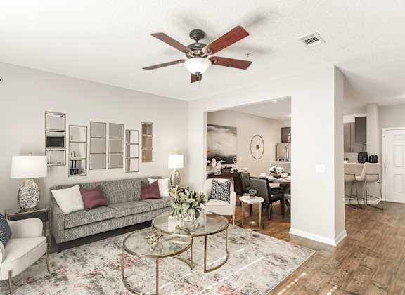 a living room with a ceiling fan and a couch