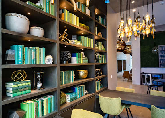 a dining room with a table and chairs and bookshelves