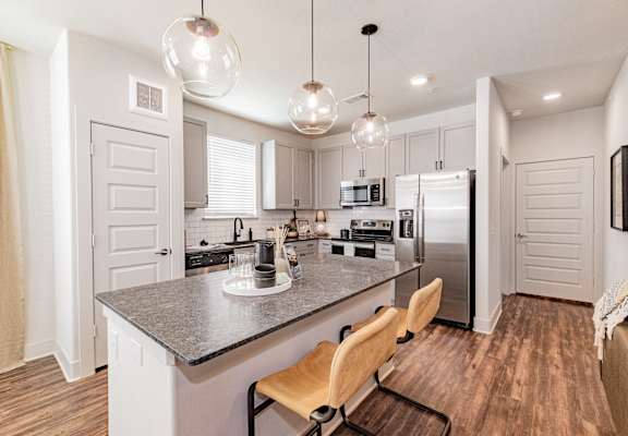 a kitchen with stainless steel appliances and granite counter tops