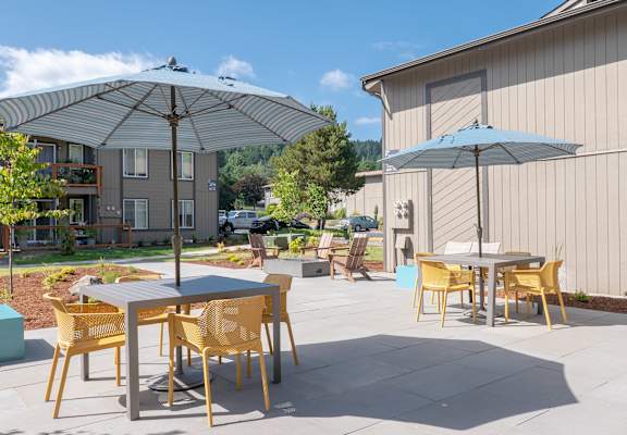 a patio with tables and umbrellas at Veri at Timberhill, Corvallis, OR, 97330