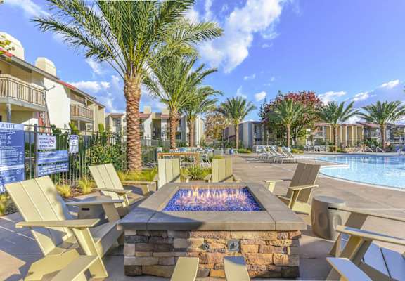 Fire pit with chairs by pool at Santee Villas, Santee, CA, 92071