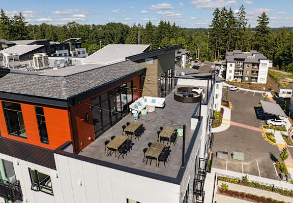 an aerial view of the exterior of a building with tables and chairs
