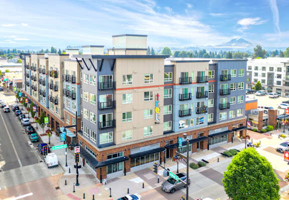 an aerial view of an apartment building on a city street