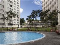 a large pool with palm trees in the background