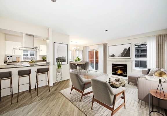 a living room with a fireplace and a kitchen with a breakfast bar