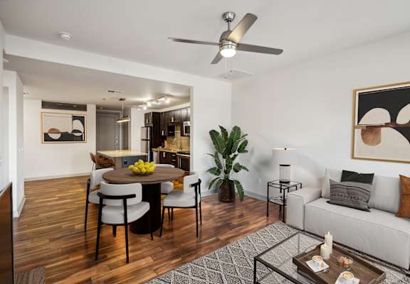 A modern living room with a dining table and chairs.