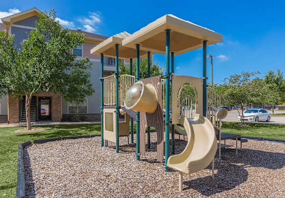 A playground with a slide and a canopy.