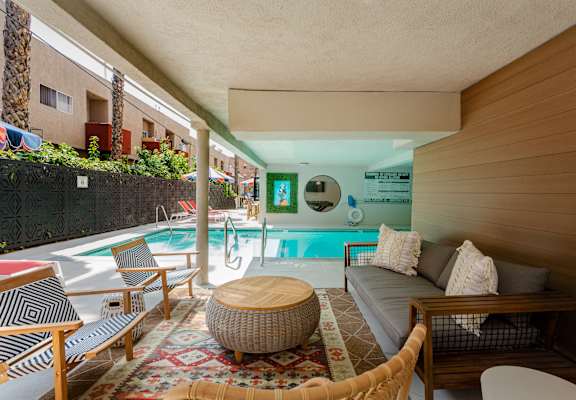 a living room with a pool and a couch
