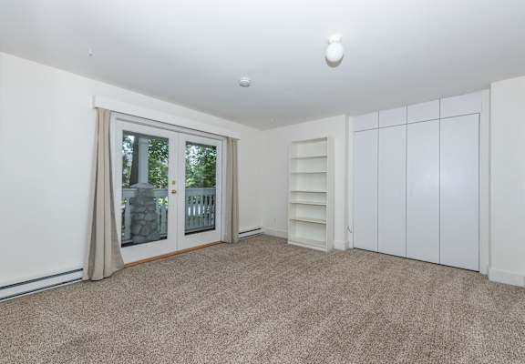 a bedroom with a door to a balcony
