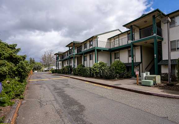 a row of townhomes with a street in front of them