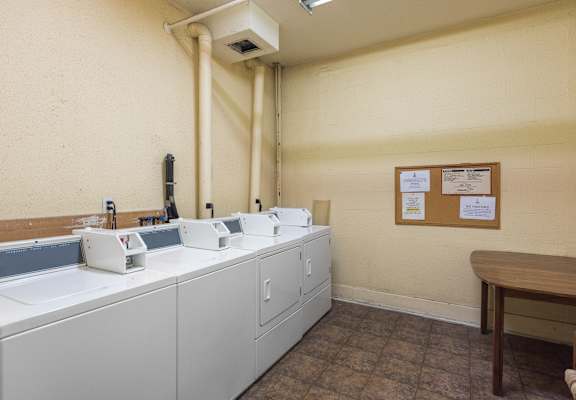 a laundry room with washers and dryers