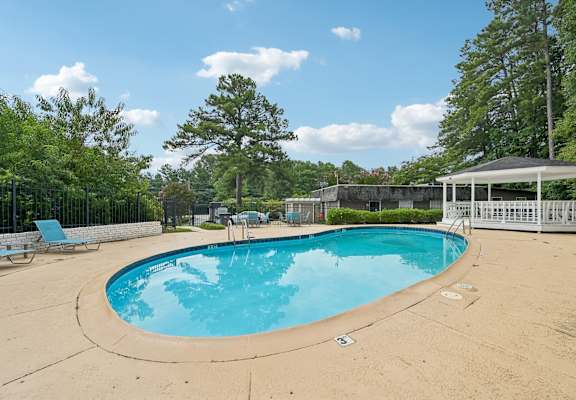 A small pool with a pavement around it.