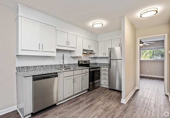 A kitchen with white cabinets and stainless steel appliances.