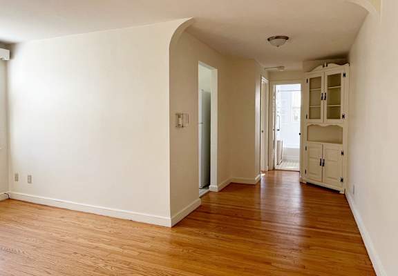A room with wooden floors and white walls.