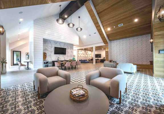 a large lobby with couches and chairs and a table