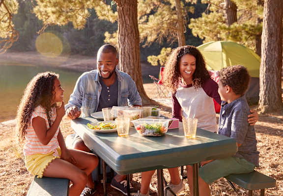 a group of people sitting around a picnic table