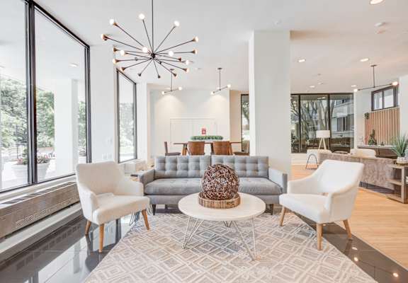 a living room filled with furniture and a large window