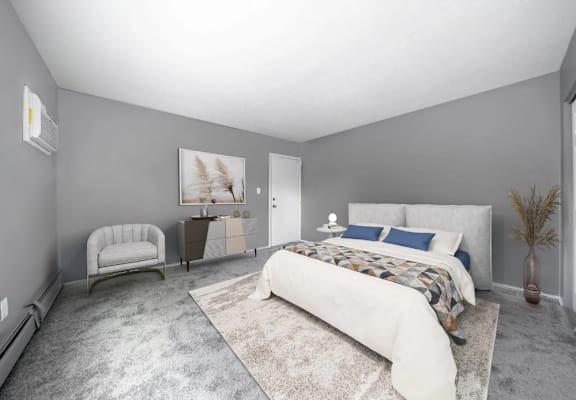 a bedroom with a medium sized bed and a chair in front of a window