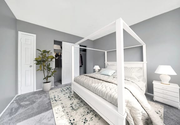 a bedroom with grey walls and a white four poster bed