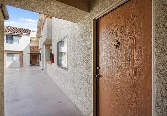 A brown door with the number 110 on it.