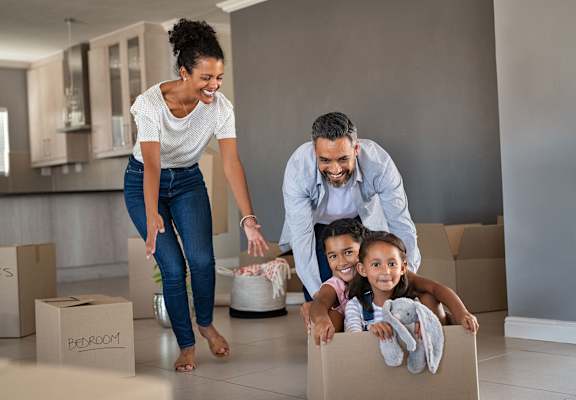 a family of three playing with a cardboard box at Fox Hill Commons, Vernon, CT, 06066
