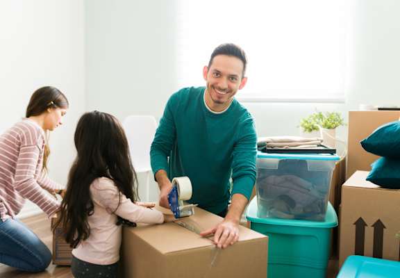 Young Family packing boxes to move at Nicole Apartments, Anchorage, AK