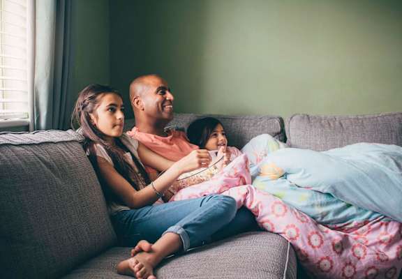 a family of three sitting on a couch at ReNew Eagle River, Eagle River, AK, 99577