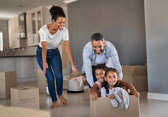 Hispanic family with moving boxes  at Manchester Green, Connecticut