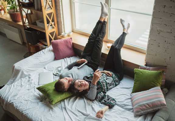 Couple relaxing on pullout couch  at Cambridge Manor Apartments, Milwaukee