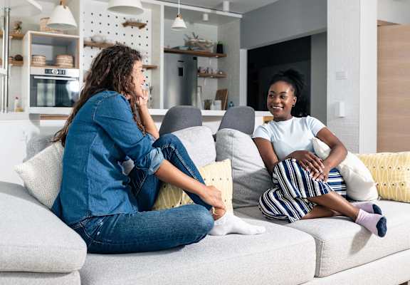 Two female roommates hanging out on couch. at ReNew at Neill Lake, Eden Prairie, Minnesota