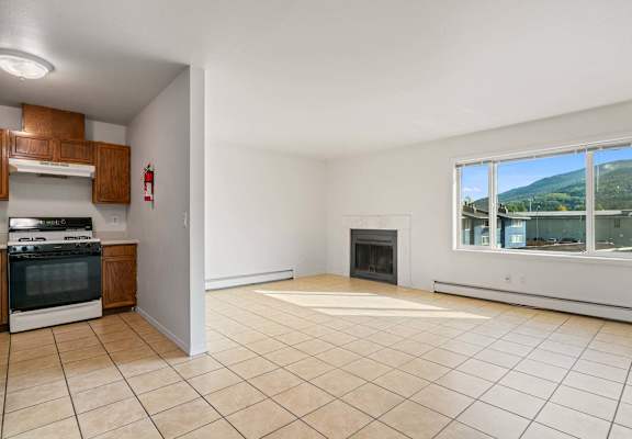 a kitchen and living room with a large window at ReNew Eagle River, Eagle River, AK