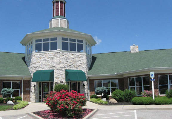A building with a stone facade and a green roof. at The Legends at Steeplechase Apartments, Richwood, KY, 41094