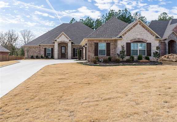 a house with a large yard in front of it