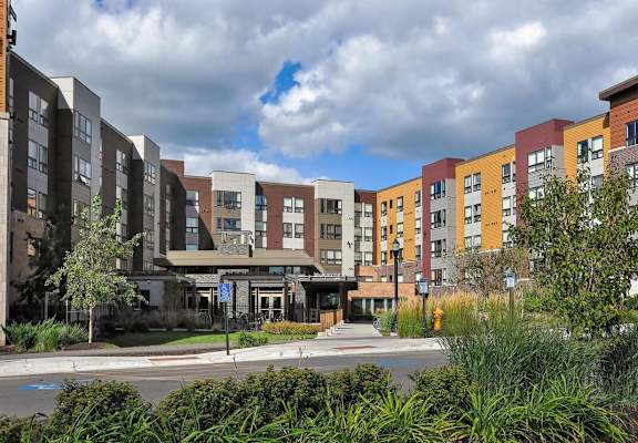 a row of new apartment buildings on a city street at Bluestone Lofts, Minnesota, 55803