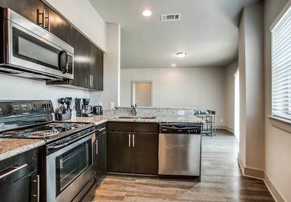 a kitchen with stainless steel appliances and a window