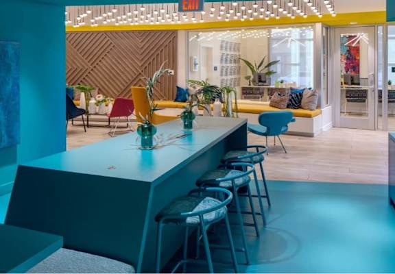 A brightly lit room with a bar and seating area.
