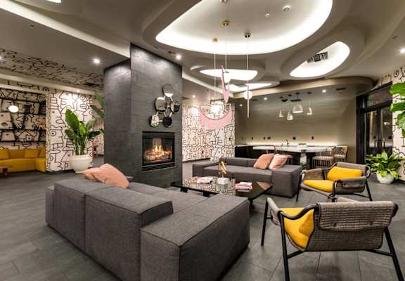 a living room with couches and chairs and a fireplace