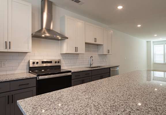 a kitchen with white cabinets and black appliances at Ainsworth, Virginia