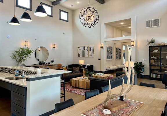 a living room with a kitchen and a dining table