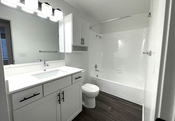 an empty bathroom with a sink toilet and shower