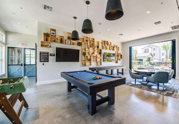 a games room with a pool table and a television at The Vineyards Apartments, California, 91326