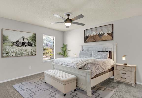 the model primary bedroom with virtual furnishings at Rock Creek Apartments