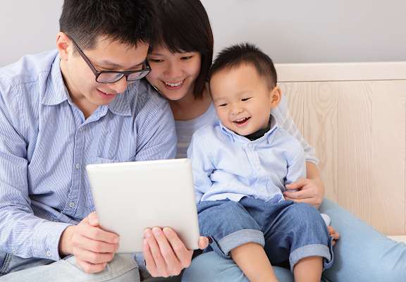 family looking at ipad
