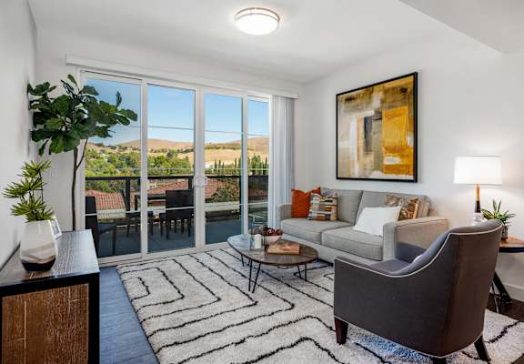 YOLO East furnished living room with patio deck