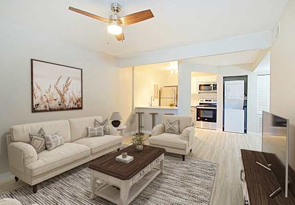 A living room with a white couch and a coffee table.