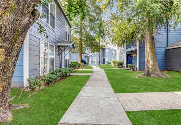 Whitney Manor Apartments in Gretna, LA photo of community buildings with greenery in between