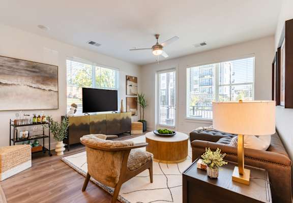 A living room with a brown chair and a brown couch.