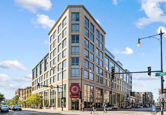 a tall building with many windows and a red target sign in front of it at Lakeview 3200 Apartments, Chicago, IL, 60657