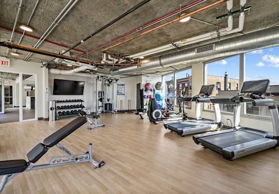 a workout room with treadmills and other exercise equipment at Lakeview 3200 Apartments, Chicago, IL, 60657