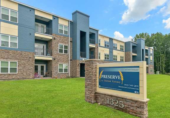 A sign in front of a building that says Preserve on it.